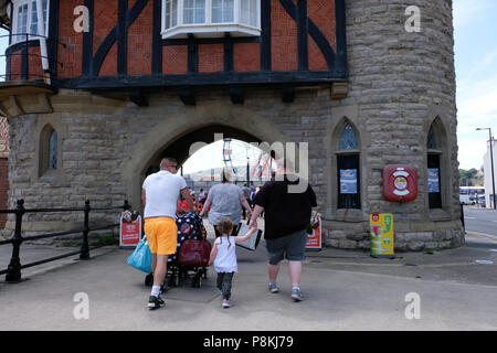 Holiday makers and families walking the promenade in the North Yorkshire holiday resort of Scarborough,UK Stock Photo