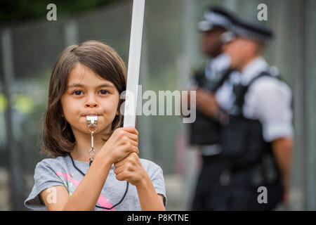 London, UK. 12th July 2018. Anti Trump activists gather outside the 'ring of steel' fence put up to seal off the residence - A protest against the visit of President Donald Trump who is staying at Winfield House, the US Ambassador’s residence in Regents Park. Credit: Guy Bell/Alamy Live News Stock Photo