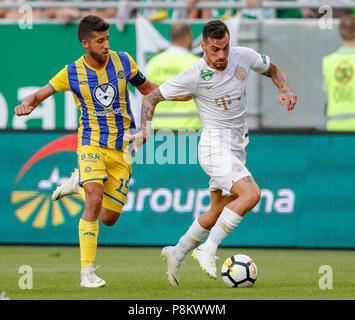 Budapest, Hungary. 12th July, 2018. (r-l) Davide Lanzafame of Ferencvarosi TC wins the ball from Dor Micha of Maccabi Tel Aviv FC during the UEFA Europa League First Qualifying Round 1st Leg match between Ferencvarosi TC and Maccabi Tel Aviv FC at Groupama Arena on July 12, 2018 in Budapest, Hungary. Credit: Laszlo Szirtesi/Alamy Live News Stock Photo