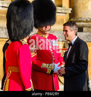 Blenheim Palace, Oxfordshire, UK. 12th July, 2018. Gavin Williamson, Secretary of State for Defence, chats to guards before the Prime Minister Theresa May of the United Kingdom and  President Donald Trump of the United States of America arrive  at Blenheim Palace, Woodstock on Thursday 12 July 2018 Credit: Julie Edwards/Alamy Live News Stock Photo