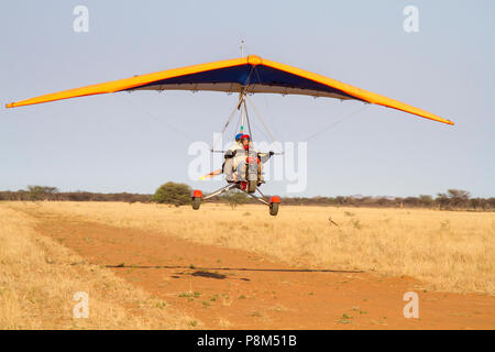 Ultra-light plane flying over sandy runway, before landing, Otjozondjupa region, Namibia Stock Photo