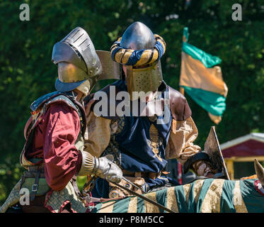 Medieval jousting, Linlithgow Palace, Scotland, UK.  HES summer entertainment  by Les Amis D'Onno equine stunt team. Knights on horses discuss tactics Stock Photo