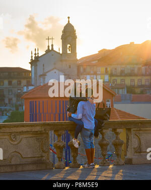 PORTO, PORTUGAL - JUN 23, 2017: Romantic couple at sunset in Porto Old Town. Porto is the second largest city and famous tourist attraction in Portuga Stock Photo