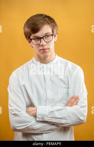 close up portrait of smirking male model in formal clothes with crossed arms Stock Photo