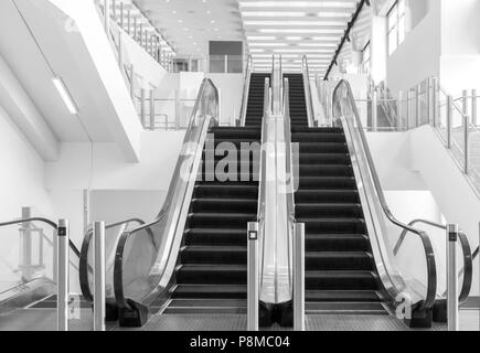 View of empty escalator in shopping mall. Black and white tone. Stock Photo