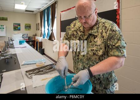 U.S. Navy HM1 Billy Joe Heap, a corpsman from Expeditionary Medical Facility Dallas, sterilizes dental instruments at a health-care clinic at Owsley County High School in Booneville, Ky. June 24, 2018, June 24, 2018. The clinic is one of four that comprised Operation Bobcat, a 10-day mission to provide military medical troops with crucial training in field operations and logistics while offering no-cost health care to the residents of Eastern Kentucky. The clinics, which operated from June 15-24, offered non-emergent medical care, sports physicals, dental cleanings, fillings and extractions, e Stock Photo