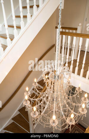 Beautiful staircase in victorian style with crystal chandelier and decorative railing Stock Photo