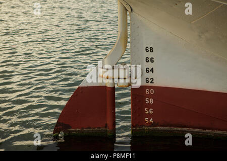 rudder of big sailig ship, made of steel, two colors - white and red Stock Photo