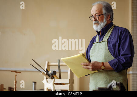 elderly pleasant male is dropping a draft. concept of own business Stock Photo