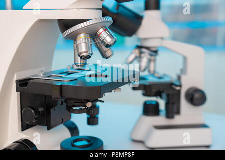 Four microscopes of different designs in the laboratory Stock Photo