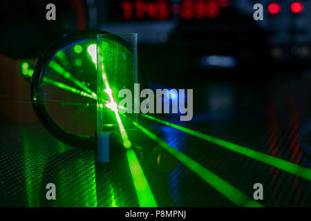 Green laser on optical table in a quantum optics laboratory Stock Photo