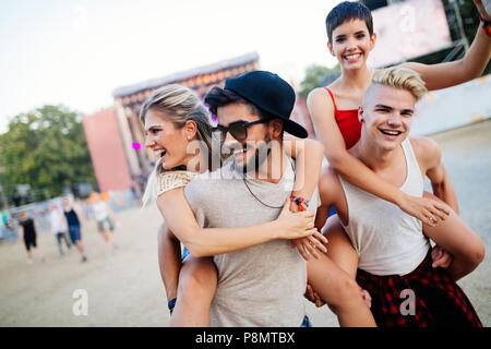 Group of friends having fun time at music festival Stock Photo