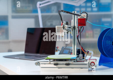 3D printer and computer on the table Stock Photo