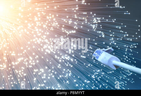 Futuristic technological background, closeup on the end of optical fiber network cable on blue-orange background Stock Photo