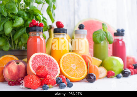 Many different fruits and berries, juice in bottles. Vitamins and healthy food. Summer Products. Copy space Stock Photo