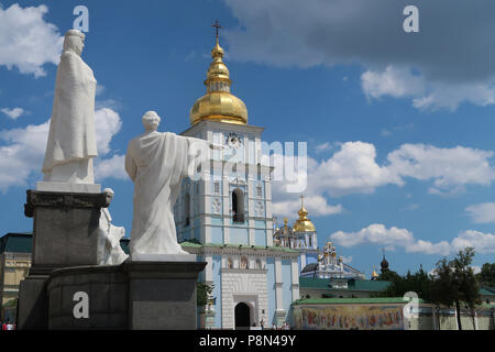 View of the statues of Saint Cyril and Methodius on St Michael Square, with the entrance to St Michael golden domed monastery in the city of Kiev capital of Ukraine Stock Photo