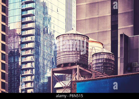 Water tanks on a roof, one of the New York City symbols, color toned picture, USA. Stock Photo