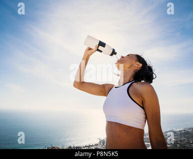 Woman drinking water from bottle Stock Photo