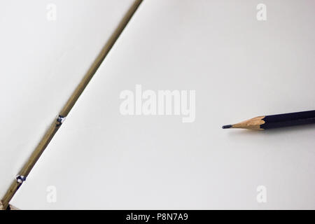 Opened notebook with pencil background with copy space. Black pencil on opened empty notebook for writing, memo, check list, diary. Stock Photo