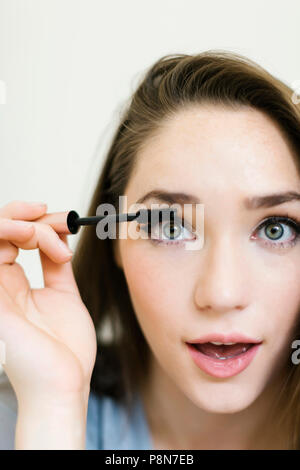 Woman applying mascara Stock Photo