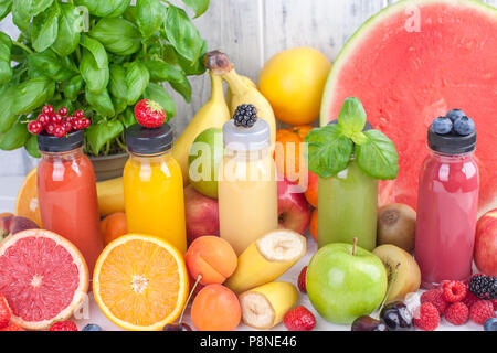Many different fruits and berries, juice in bottles. Vitamins and healthy food. Summer Products. Copy space Stock Photo