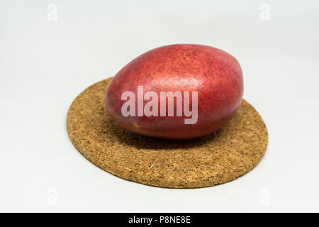 red mango fruit on cork isolated on white background Stock Photo