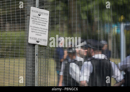 American Secret Service and UK police guard a temporary perimeter fence encircling Winfield House, the official residence of the US Ambassador during the visit to the UK of US President, Donald Trump, on 12th July 2018, in Regent's Park, London, England. Stock Photo