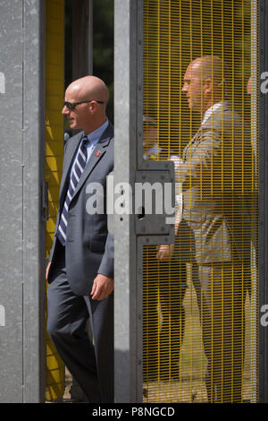 American Secret Service and UK police guard a temporary perimeter fence encircling Winfield House, the official residence of the US Ambassador during the visit to the UK of US President, Donald Trump, on 12th July 2018, in Regent's Park, London, England. Stock Photo