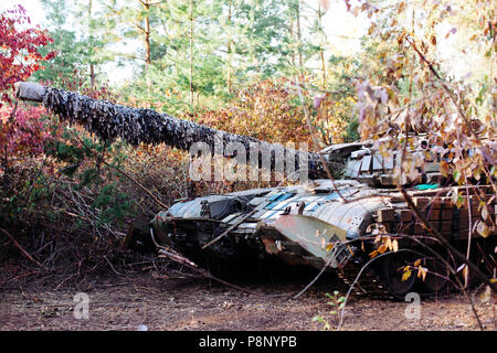 The tank from the hidden position is disguised in the trench Stock Photo