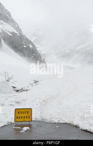 Dramatic atmosphere during springtime in the French Alps with the snow melting and clouds hanging low Stock Photo