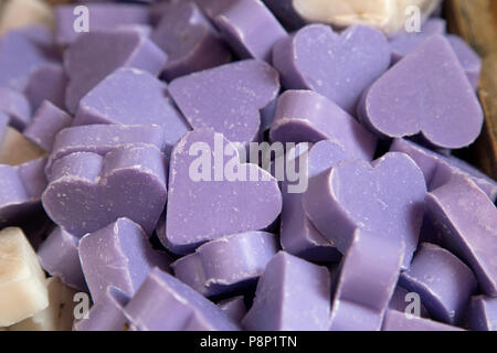 Lilac coloured heart-shaped soap bars shot close up to fill the frame Stock Photo