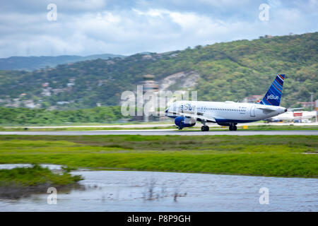 Montego Bay, Jamaica - April 11 2015: JetBlue aircraft on the runway at Sangster International Airport (MBJ) in Montego Bay, Jamaica. Stock Photo