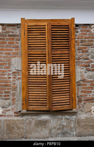 Wooden blinds on windows on the street Stock Photo