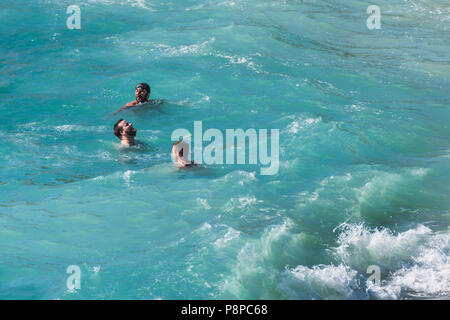 Friends enjoying themselves in the sea. Stock Photo