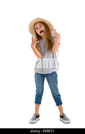 Angry young girl in jeans and a straw sunhat standing clawing at the air and gnashing her teeth isolated on white Stock Photo