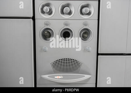 Air condition unit and lighting of aerospace on the ceiling of passenger cabin. Modern Airplane seats in perspective. Transportation concept. Aircraft long-distance international flight Stock Photo