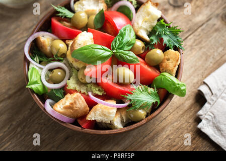 Panzanella Tomato Salad with cherry tomatoes, basil and ciabatta croutons. Summer healthy food - panzanella salad, close up. Stock Photo
