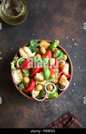 Panzanella Tomato Salad with cherry tomatoes, basil and ciabatta croutons. Summer healthy food - panzanella salad, top view, copy space. Stock Photo