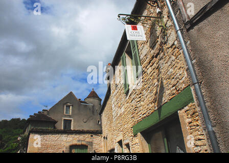 Charming Medieval Noyers-Sur-Serein in Burgundy France.  This shot is meant to capture the architectural detail of the roof tops, as well as the sign  Stock Photo