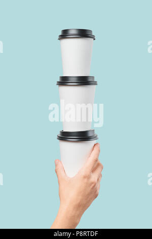 Crop hand holding stack of paper cups Stock Photo