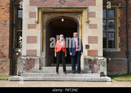 US President Donald Trump stands with Prime Minister Theresa May on the doorstep at Chequers, her country residence in Buckinghamshire. Stock Photo