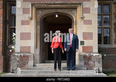 Prime Minister Theresa May greets US President Donald Trump on the doorstep at Chequers, after he arrived for talks at her country residence in Buckinghamshire. Stock Photo