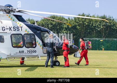 Paramedics and doctor of Kent, Surrey, Sussex Helimed air ambulance helicopter attending incident in England, UK. Aircraft is AgustaWestland AW169. Stock Photo