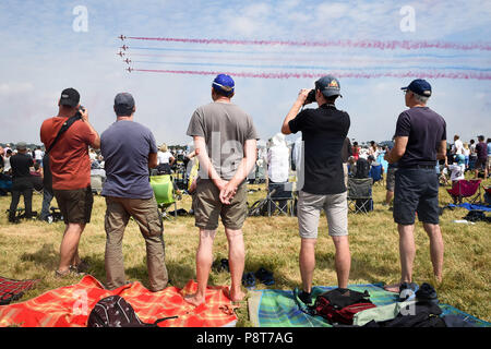 People watch the Red Arrows perform at the 2018 Royal International Air Tattoo at RAF Fairford in Gloucestershiire. Stock Photo