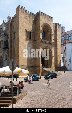 The main, fortress-like, entrance to the old Romanesque Cathedral (13th century), in Coimbra, Portugal Stock Photo