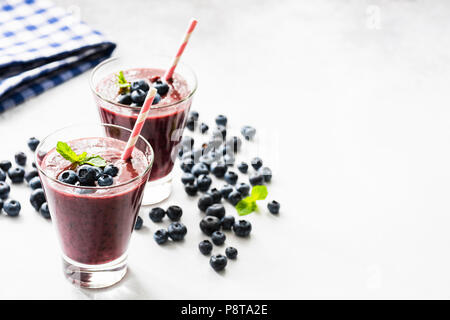 Acai blueberry smoothie in glass, isolated on white. Closeup view, selective focus Stock Photo