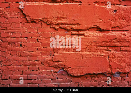 A wall of red brick, and a destroyed cement. Background from plaster of old, stone Stock Photo