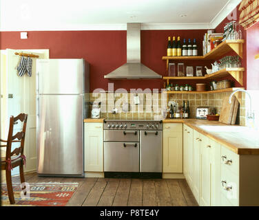 Modern kitchen cream units stainless steel fridge interiors kitchens  appliances Stock Photo - Alamy