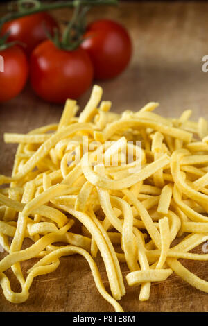 Raw yellow noodles made from white flour and eggs - close up view Stock Photo