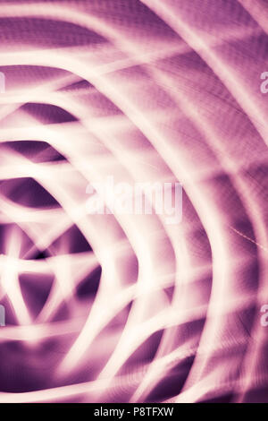 Abstract background made by zooming and rotating camera pointed at city lights at night. Stock Photo